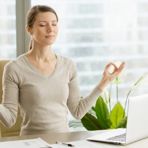 calm businesswoman relaxing with breath gymnastics