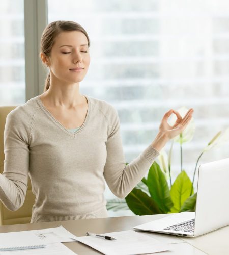 Calm businesswoman relaxing with breath gymnastics