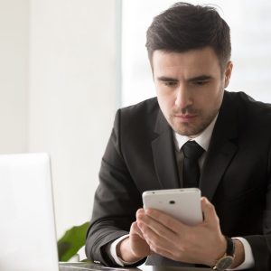 male business leader browsing online resources using gadgets